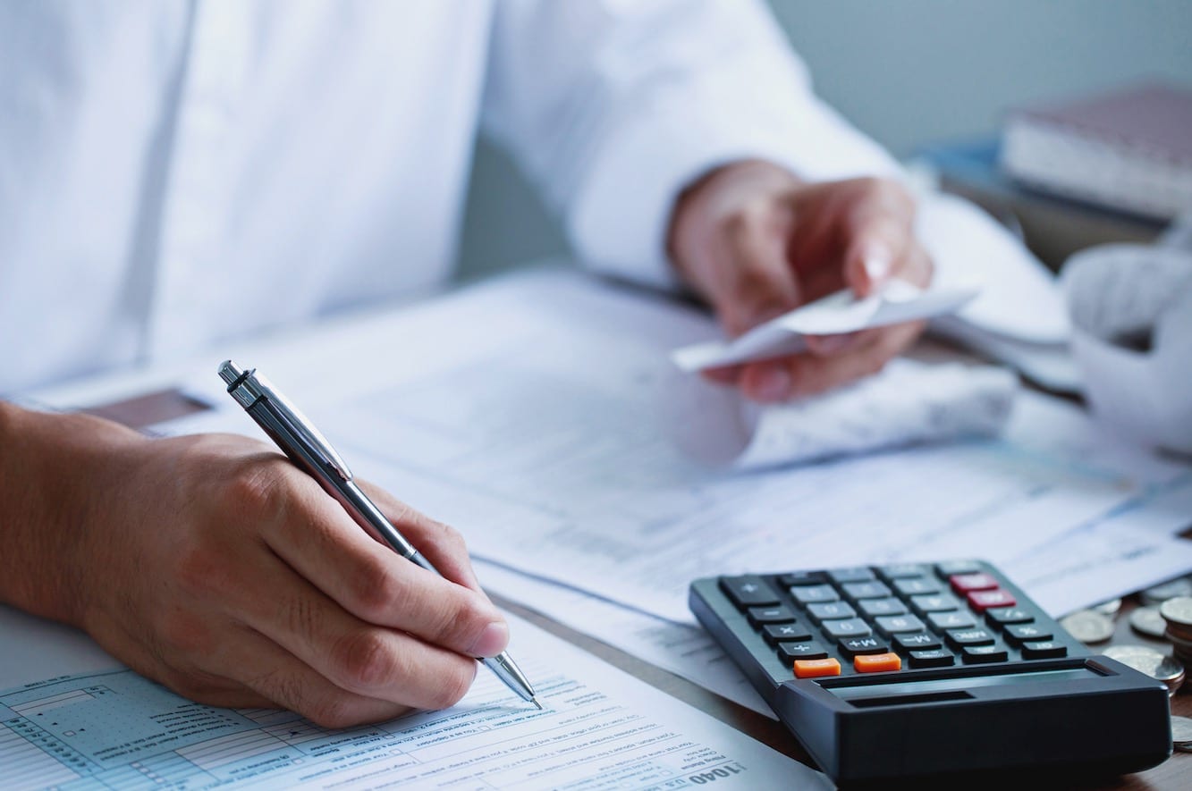 Accountant Preparing Tax Return With Calculator