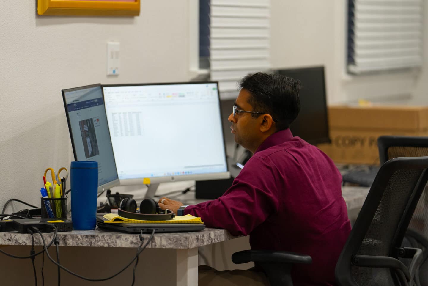 Accountant Reviewing Financial Data At Dual Monitors